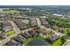 The property and surrounding community are displayed from a high angle featuring access to a nearby lake at 4506 Stickley Ct, Palmetto, FL 34221