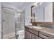 Bathroom featuring an enclosed shower, granite counters, and decorative mirror at 4506 Stickley Ct, Palmetto, FL 34221