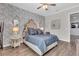 Beautiful bedroom featuring hardwood floors, ceiling fan, and tufted headboard for an upscale look at 4506 Stickley Ct, Palmetto, FL 34221