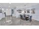 Dining room featuring gray chairs, dining table, decorative chandelier, and front door view at 4506 Stickley Ct, Palmetto, FL 34221
