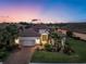 Stunning exterior twilight shot of the home showing professional landscaping and pristine curb appeal at 4506 Stickley Ct, Palmetto, FL 34221