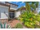 Charming front entrance with a brick walkway, double doors, and lush tropical landscaping at 4506 Stickley Ct, Palmetto, FL 34221