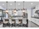 A modern kitchen featuring white cabinets, granite counters, and a large center island with bar seating at 4506 Stickley Ct, Palmetto, FL 34221