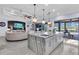 Open kitchen with large island and access to the outdoor pool and seating area at 4506 Stickley Ct, Palmetto, FL 34221