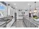Well-equipped kitchen featuring gray counters, white cabinets, and a center island at 4506 Stickley Ct, Palmetto, FL 34221
