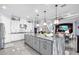 Spacious kitchen featuring a gray marble island, stainless steel appliances, and pendant lighting at 4506 Stickley Ct, Palmetto, FL 34221