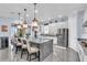 An open concept kitchen featuring stainless steel appliances, pendant lighting, and granite counters at 4506 Stickley Ct, Palmetto, FL 34221