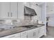 Stylish kitchen highlighting a stainless steel range hood and white cabinets at 4506 Stickley Ct, Palmetto, FL 34221