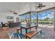 Inviting lanai with a dining area, comfortable seating, and views of the pool and garden at 4506 Stickley Ct, Palmetto, FL 34221