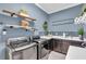 Well-appointed laundry room with modern washer and dryer, ample cabinet space, and stylish decor at 4506 Stickley Ct, Palmetto, FL 34221