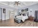 Tranquil main bedroom featuring a tray ceiling, wood floors, and ensuite bathroom at 4506 Stickley Ct, Palmetto, FL 34221