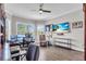 Bright office with a ceiling fan, hardwood floors, built in bookshelves, and a large window at 4506 Stickley Ct, Palmetto, FL 34221