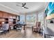Bright office with a ceiling fan, hardwood floors, built in bookshelves, and a large window at 4506 Stickley Ct, Palmetto, FL 34221