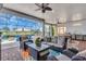Inviting screened-in patio featuring a comfortable seating area, a summer kitchen, and a view of the sparkling pool at 4506 Stickley Ct, Palmetto, FL 34221