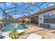 Enclosed lanai featuring a sparkling pool, lounge chairs, and beautiful outdoor views for relaxation at 4506 Stickley Ct, Palmetto, FL 34221