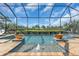 Screened in pool featuring fountains and overlooking a serene lake view and lush landscaping at 4506 Stickley Ct, Palmetto, FL 34221