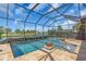 Inviting screened pool and spa overlooking scenic lake views surrounded by lush greenery at 4506 Stickley Ct, Palmetto, FL 34221