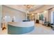 Elegant reception area with a modern curved desk, stylish decor, and a bright, welcoming atmosphere at 4506 Stickley Ct, Palmetto, FL 34221