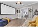 View of the media room showing projector screen, light walls and hardwood floors at 4506 Stickley Ct, Palmetto, FL 34221