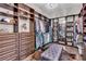 Spacious walk-in closet with custom shelving, drawers, and a central ottoman for added luxury at 4506 Stickley Ct, Palmetto, FL 34221
