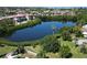 Aerial view of a community lake surrounded by lush greenery and nearby buildings at 4550 Overlook Ne Dr # 156, St Petersburg, FL 33703