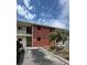 Building exterior showing brick facade, balconies, and landscaping with a small palm tree at 4550 Overlook Ne Dr # 156, St Petersburg, FL 33703