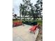 Community grilling area features charcoal grills and red benches perfect for outdoor gatherings and relaxation at 4550 Overlook Ne Dr # 156, St Petersburg, FL 33703