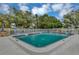 Inviting community pool area featuring lounge chairs and a secure, fenced perimeter at 4550 Overlook Ne Dr # 156, St Petersburg, FL 33703