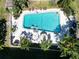 Aerial shot of a refreshing community swimming pool with lounge chairs and palm trees at 4550 Overlook Ne Dr # 156, St Petersburg, FL 33703