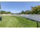 Expansive backyard with a white picket fence and lush green grass, perfect for outdoor activities at 511 York Dale Dr, Ruskin, FL 33570