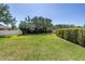 Large grassy backyard featuring mature trees, well-maintained fence, and a shed for additional storage at 511 York Dale Dr, Ruskin, FL 33570