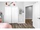 Bedroom with a closet featuring double doors, complemented by wood-look flooring at 511 York Dale Dr, Ruskin, FL 33570