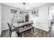 Stylish dining room boasting a dark wood table, bench seating, and a modern chandelier at 511 York Dale Dr, Ruskin, FL 33570