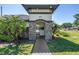 Stone-accented entrance to the community's recreational area with lush landscaping and clear signage, all under a bright sky at 511 York Dale Dr, Ruskin, FL 33570