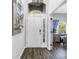 Inviting foyer with a front door, transom window, and view of a bright home office space at 511 York Dale Dr, Ruskin, FL 33570