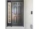 Elegant black front door with sidelight and modern smart lock, offering style and security at 511 York Dale Dr, Ruskin, FL 33570