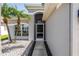 Charming front entrance with a decorative archway, modern door, and lush landscaping at 511 York Dale Dr, Ruskin, FL 33570