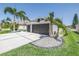 Spacious three-car garage with lush landscaping, palm trees and a wide driveway at 511 York Dale Dr, Ruskin, FL 33570