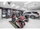 Well-organized garage showcasing motorcycles, SUV, epoxy floors and custom decor at 511 York Dale Dr, Ruskin, FL 33570