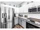 Bright kitchen equipped with stainless steel appliances, granite counters, and white tile backsplash at 511 York Dale Dr, Ruskin, FL 33570