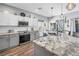 Modern kitchen features stainless steel appliances, granite countertops, and stylish white and gray cabinetry at 511 York Dale Dr, Ruskin, FL 33570