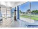 Enclosed lanai with tiled floors, bright windows, and a beautiful backyard view at 511 York Dale Dr, Ruskin, FL 33570