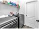 Functional laundry room equipped with a washer, dryer, and ample shelving space at 511 York Dale Dr, Ruskin, FL 33570