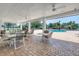 A spacious, covered outdoor patio with tables, chairs, and ceiling fans adjacent to the community pool at 511 York Dale Dr, Ruskin, FL 33570