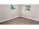 Cozy bedroom with new flooring and two windows offering natural light at 5111 N 30Th St, Tampa, FL 33610