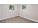 Bedroom featuring new flooring and two windows offering natural light at 5111 N 30Th St, Tampa, FL 33610