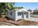 A cozy house featuring a blue front door and shutters with neat landscaping and a modern exterior at 5111 N 30Th St, Tampa, FL 33610