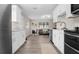 Modern kitchen design with white cabinets, stainless appliances, and an open view to the living area at 5111 N 30Th St, Tampa, FL 33610