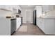 Bright kitchen with white cabinets, stainless steel appliances, and modern countertops at 5111 N 30Th St, Tampa, FL 33610