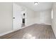 Open living room featuring new laminate flooring and access to the kitchen and hall at 5111 N 30Th St, Tampa, FL 33610
